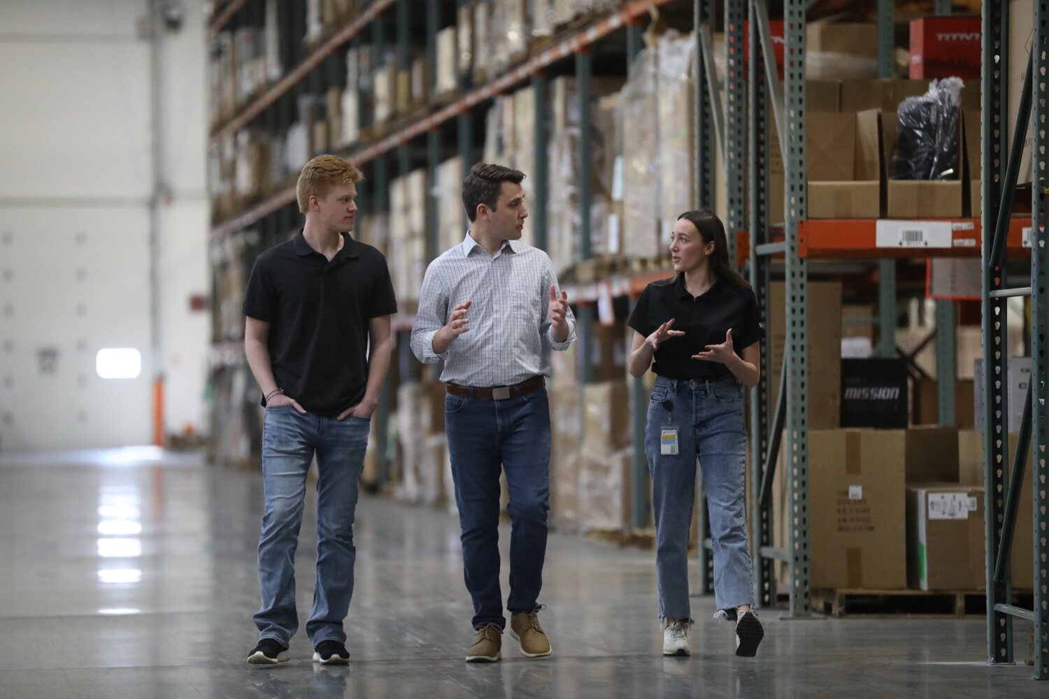 Andrew Ireland touring a local warehouse and speaking with employees