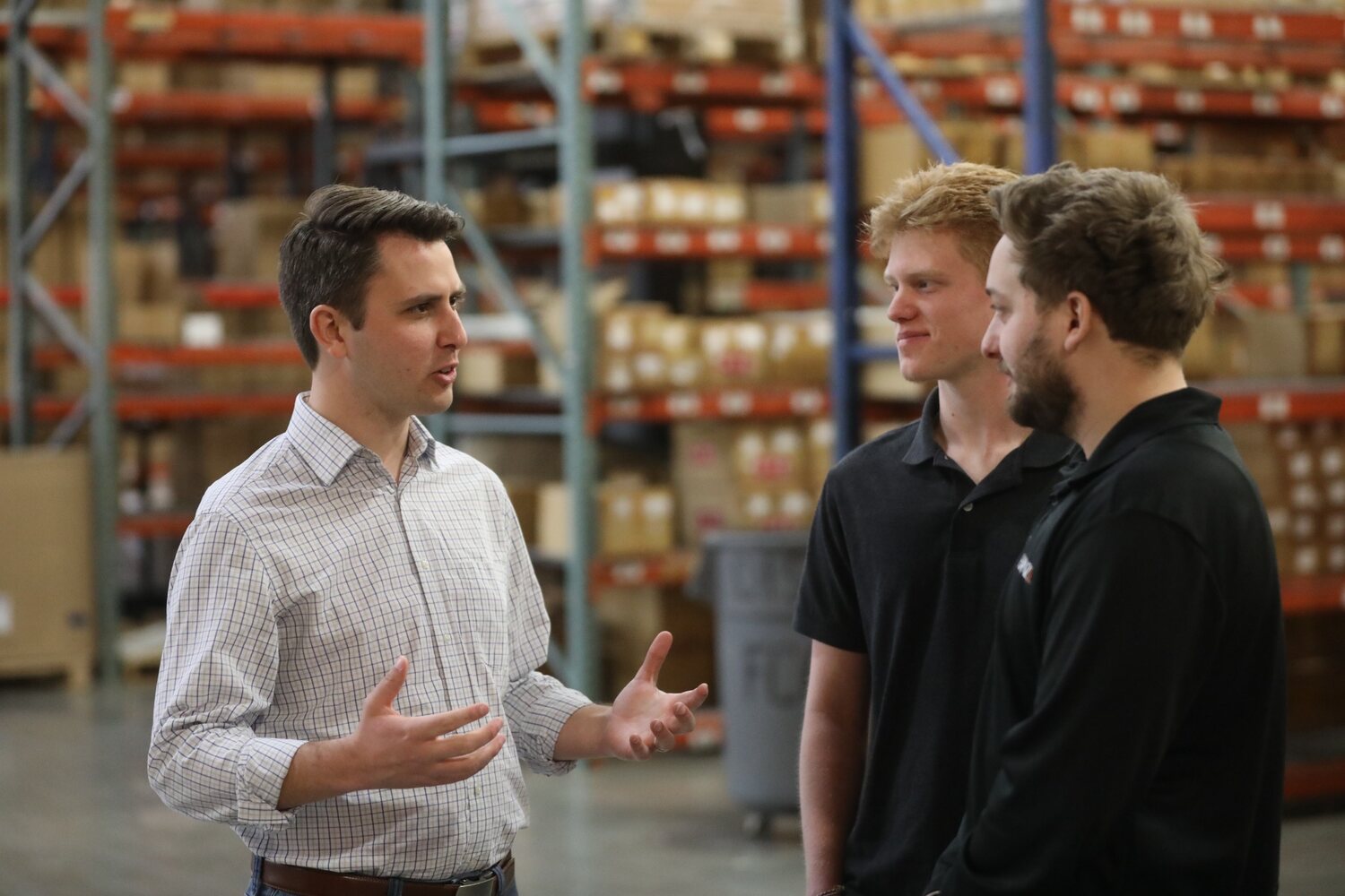 Andrew Ireland speaking with employees during a local warehouse tour